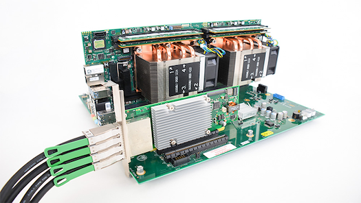 This is a photo of a PCIe expansion kit plugged into a PCIe slot on a backplane and dual-CPU processor board combo.