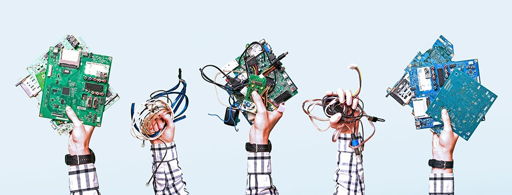 This is a photo of individuals holding various electronics, such as motherboards.