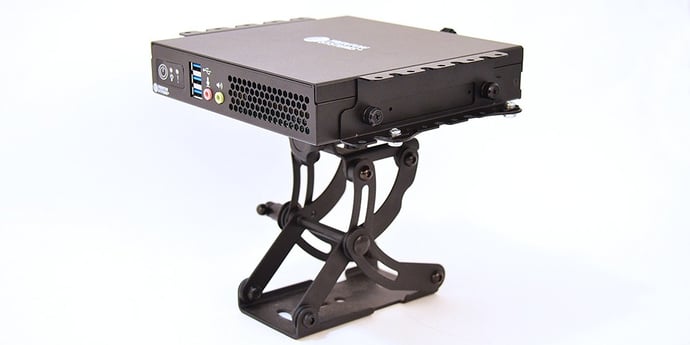 A rugged mini PC supported by a VESA mount.