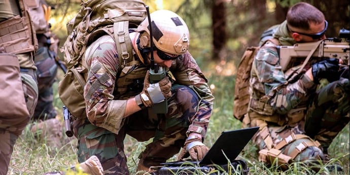 A soldier in the field communicates with command