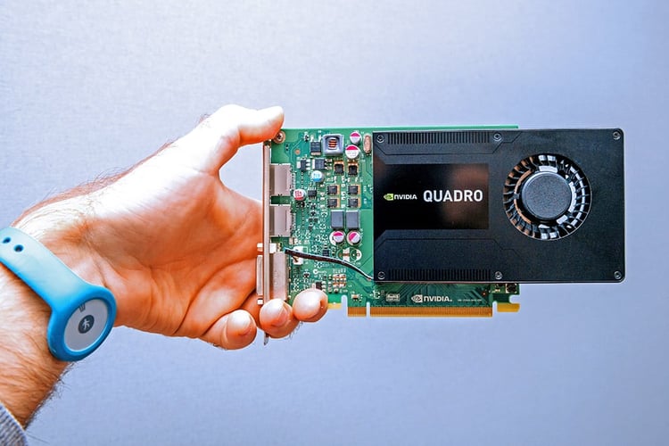 A person holding an NVIDIA Quadro Graphics Processing Unit (GPU)