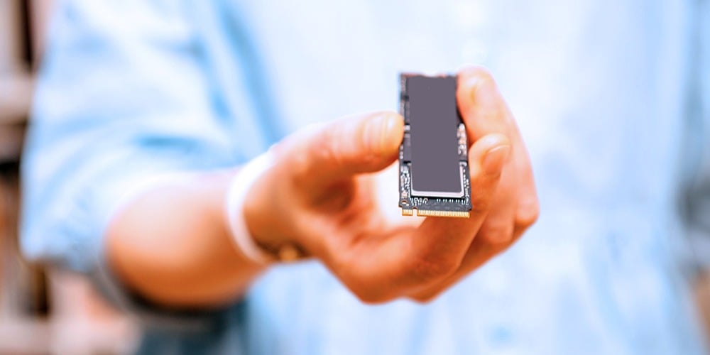 A person holds an PCIe 4.0 SSD (NVMe)