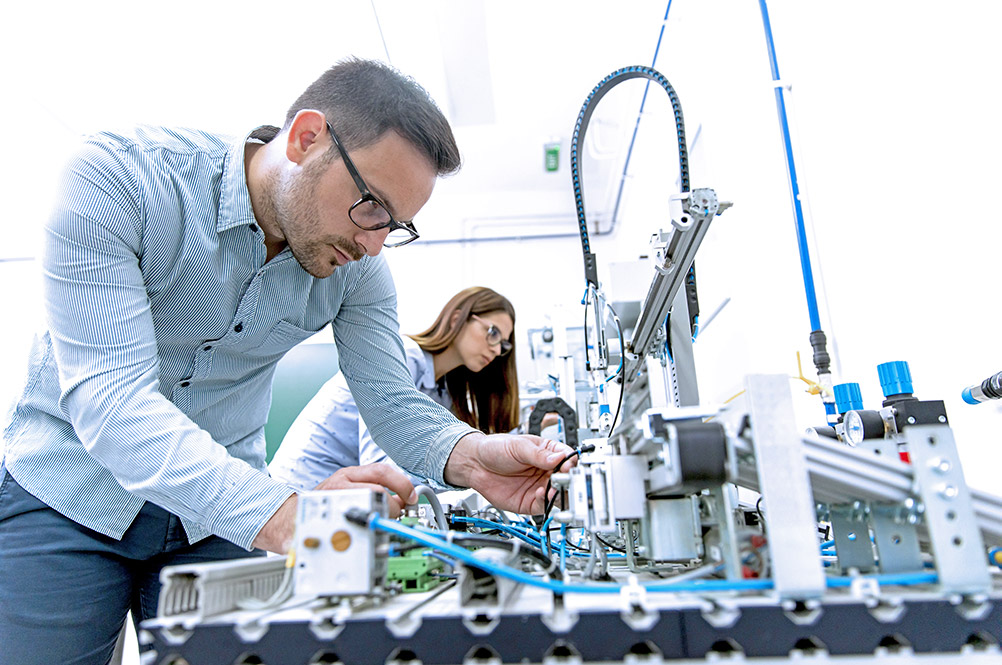 Two students in a university robotics lab